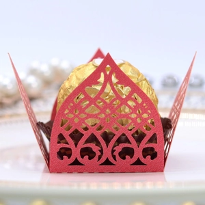 Detailed laser-cut hollow red paper chocolate wrapper with elegant geometric patterns
