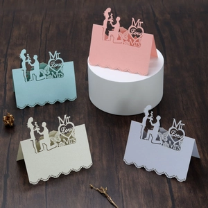 Macro detail of laser-cut heart place cards with Mr & Mrs text on pearlescent paper