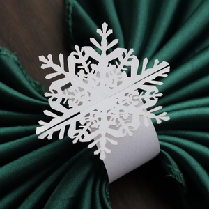 White snowflake paper napkin ring with laser cut pattern for Christmas table decor
