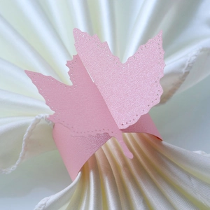 Detail of pink laser-cut maple leaf napkin ring made from shimmering pearlescent paper