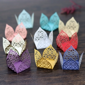 Detailed laser-cut hollow pearl paper candy boxes in various colors with intricate patterns