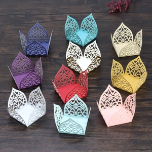 Macro view of multi-color laser-cut paper candy boxes with delicate floral lace textures