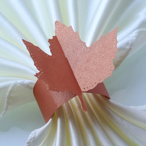 Detail of rose gold butterfly paper napkin ring with glitter finish and cutout edges