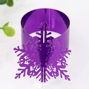 Macro shot of purple metallic snowflake napkin ring with intricate laser-cut detail