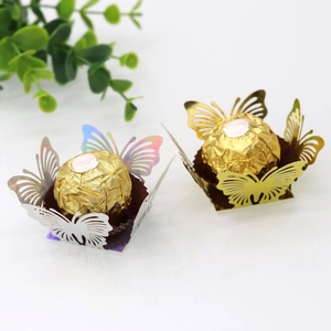 Macro detail of laser-cut butterfly chocolate liners in gold and holographic finish