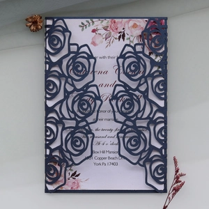 Detail of laser-cut navy blue rose envelope and floral wedding invitation card