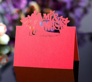 Laser-cut red wedding place card with Mr & Mrs silhouette and intricate hollow patterns