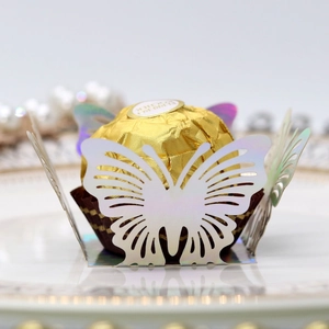 Macro shot of laser-cut butterfly chocolate holder in iridescent pearl white paper
