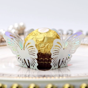 Macro view of laser-cut butterfly chocolate paper holder with pearl white finish