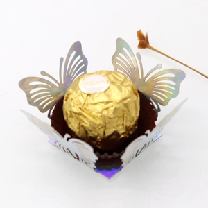 Close-up of laser-cut hollow butterfly candy box insert in reflective silver paper