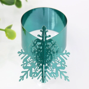 Macro detail of glossy green metallic snowflake napkin ring for Christmas dinner table