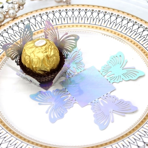 Close-up of laser-cut butterfly hollow candy box with iridescent finish for wedding