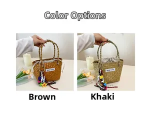 Detail of woven straw beach bags in brown and khaki with colorful tassels and star charms