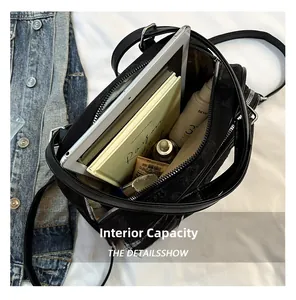 Compartiment intérieur spacieux d'un sac à bandoulière noir avec tablette et cosmétiques