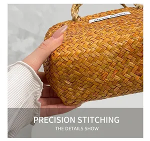 Detailed view of handmade straw bag with intricate natural fiber weaving and brand label