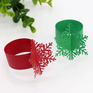 3D laser-cut snowflake paper napkin rings in festive red and green for Christmas table decor