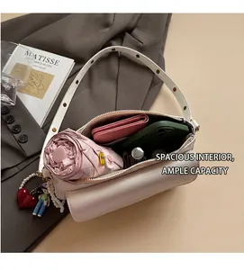 Top view of white shoulder bag showing spacious interior with phone, wallet and umbrella