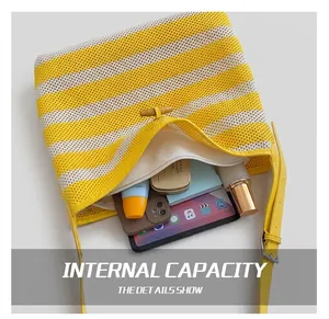 Detail showing the large interior capacity of the yellow striped knit tote bag