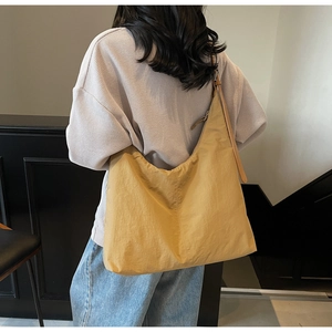 Detailed close-up of a mustard yellow high-capacity nylon tote bag for commuting
