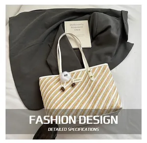 Detail of striped woven tote bag with white leather handles and metallic brand logo