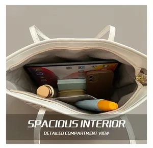 Top view showing the spacious interior of white tote bag with tablet and cosmetics