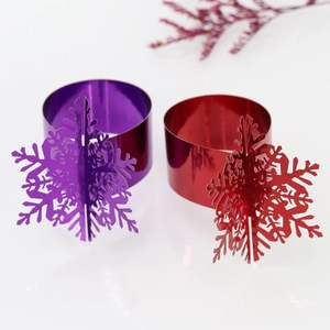 Detail of red and purple metallic snowflake napkin rings for Christmas table decor
