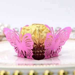 Close-up of laser-cut pink butterfly candy holder with delicate lace hollow pattern