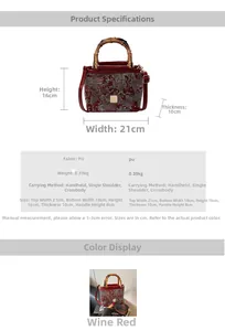 Detail of burgundy embroidery handbag with bamboo handle and gold square clasp closure