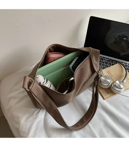 Interior view showing the spacious capacity of this brown pebble leather dumpling bag