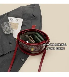 Detail view showing spacious interior with pockets for phone and makeup in red embroidered bag