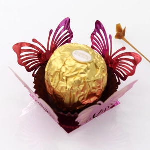 Laser-cut butterfly candy box in shiny purple with detailed wing patterns for weddings