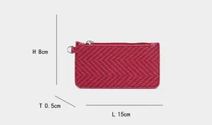 Macro detail of red woven leather wallet with zipper showing 15cm x 8cm x 0.5cm dimensions
