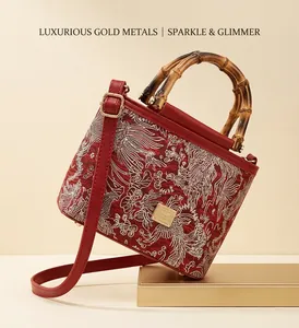 Detail of red Chinese style bucket bag with crane embroidery and bamboo handle