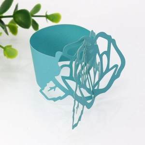 Macro shot of light blue laser-cut rose napkin ring with a pearlescent paper finish