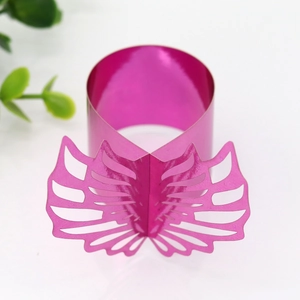 Close-up of laser-cut hot pink butterfly napkin rings with intricate hollow patterns