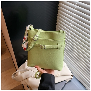 Détail du sac seau vert citron à motif litchi avec boucle argentée et breloque canard