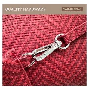 Macro view of a red woven tote bag featuring a polished silver metal twist lock closure