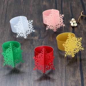 Detail of five colored 3D snowflake paper napkin rings for Christmas table decor