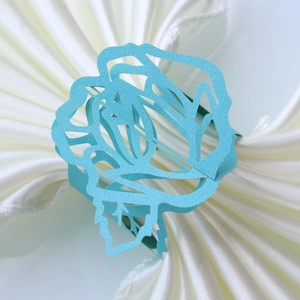 Detail of tiffany blue rose napkin ring with laser cut pattern for wedding decor