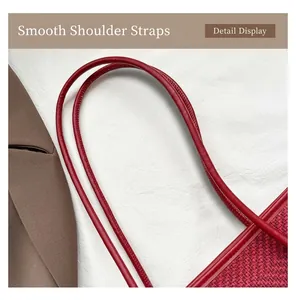 Close-up of red leather strap and houndstooth texture on stylish tote bag