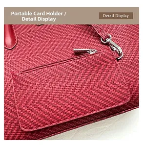 Detail view of red woven card holder featuring premium metal zipper and swivel hook