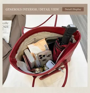 Interior view showing large capacity and zipper pocket of the dark red leather tote bag