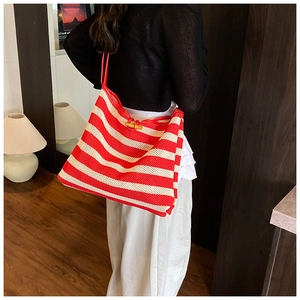 Detail of red and white striped tote bag with elegant bamboo wooden closure buckle