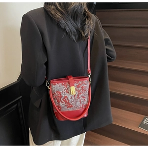 Red Neo-Chinese bucket bag with traditional embroidery detail shown on model back