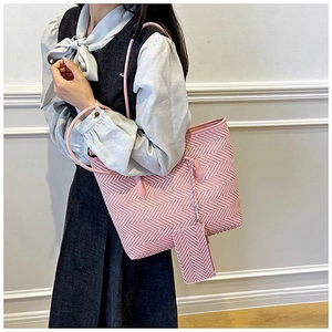 Detail of pink herringbone tote bag with matching pouch and slim leather handles