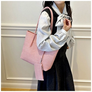 Detail of pink and white herringbone woven tote bag with matching zipper pouch