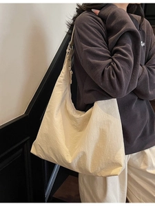 Minimalist off-white oversized tote bag with adjustable shoulder strap for women