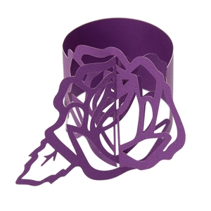 Macro shot of purple laser-cut paper napkin ring with 3D hollow rose design for weddings