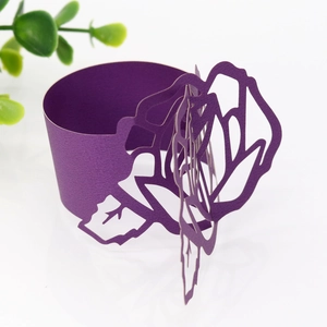 Macro detail of laser-cut dark purple rose paper napkin ring with a pearl luster finish
