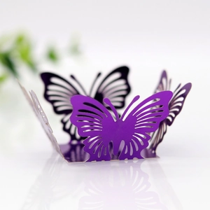 Close-up of purple laser-cut butterfly wedding candy box with intricate hollow patterns